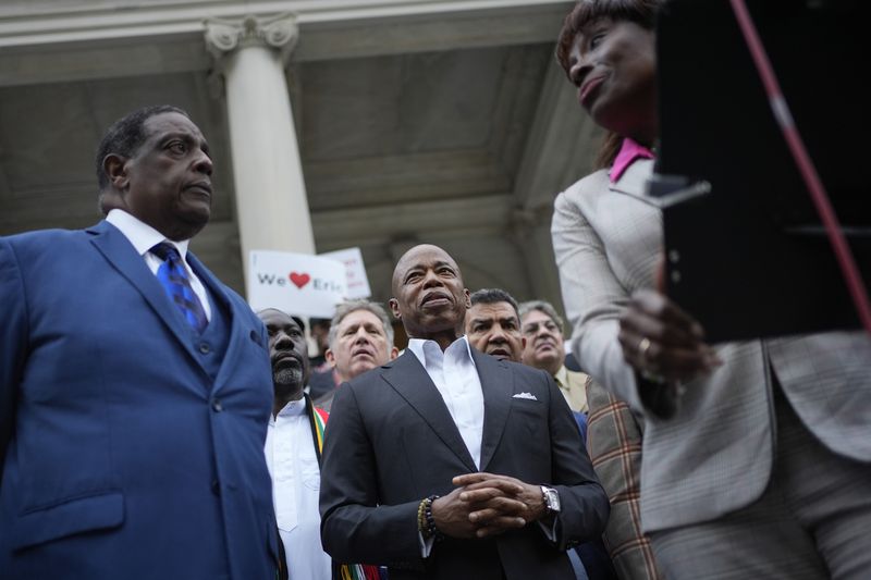 New York City Mayor Eric Adams is surrounded by faith leaders and other supporters during a rally and prayer vigil on the steps of City Hall in New York, Tuesday, Oct. 1, 2024. (AP Photo/Seth Wenig)