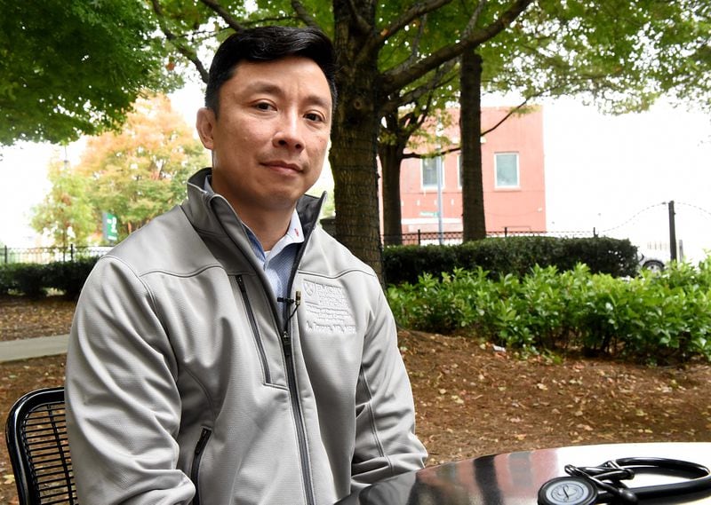 Dr. Alex Truong, an Emory pulmonologist who helped start a long COVID clinic, sits for a portrait outside of Emory University Hospital Midtown on Nov. 3, 2021. Ryon Horne/RHORNE@AJC.COM