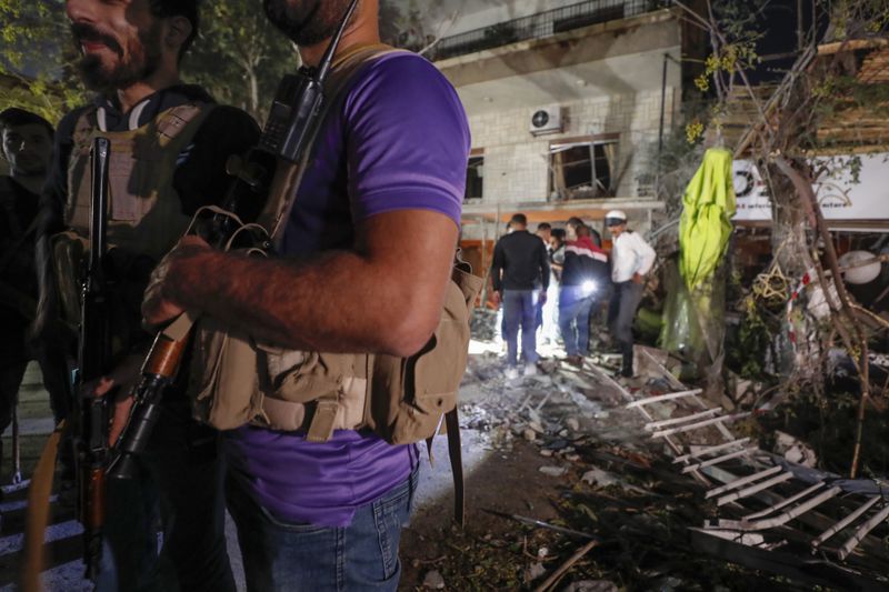 Police stand guard at the site of an apparent Israeli airstrike in Damascus, Syria, Wednesday, Oct. 2, 2024. (AP Photo/Omar Sanadiki)