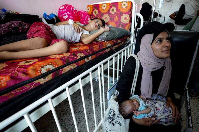 Palestinian children wait to receive a polio vaccination at a hospital in Khan Younis, Saturday, Aug. 31, 2024. (AP Photo/Abdel Kareem Hana)