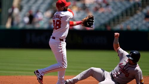 Los Angeles Angels second baseman Michael Stefanic, left, throws out Atlanta Braves designated hitter Marcell Ozuna at first base to complete a double play after forcing out Austin Riley, right, during the first inning of a baseball game, Sunday, Aug. 18, 2024, in Anaheim, Calif. (AP Photo/Ryan Sun)