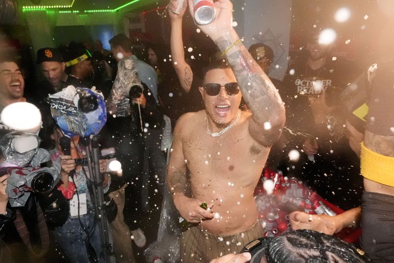 San Diego Padres' Manny Machado celebrates after the Padres clinched a playoff spot with a triple play to end their baseball game against the Los Angeles Dodgers, Tuesday, Sept. 24, 2024, in Los Angeles. (AP Photo/Mark J. Terrill)