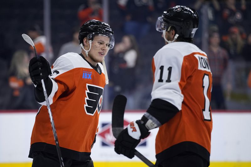 Philadelphia Flyers' Matvei Michkov, left, and Travis Konecny celebrate after a preseason NHL hockey game against the New York Islanders, Thursday, Sept. 26, 2024, in Philadelphia. (AP Photo/Matt Slocum)