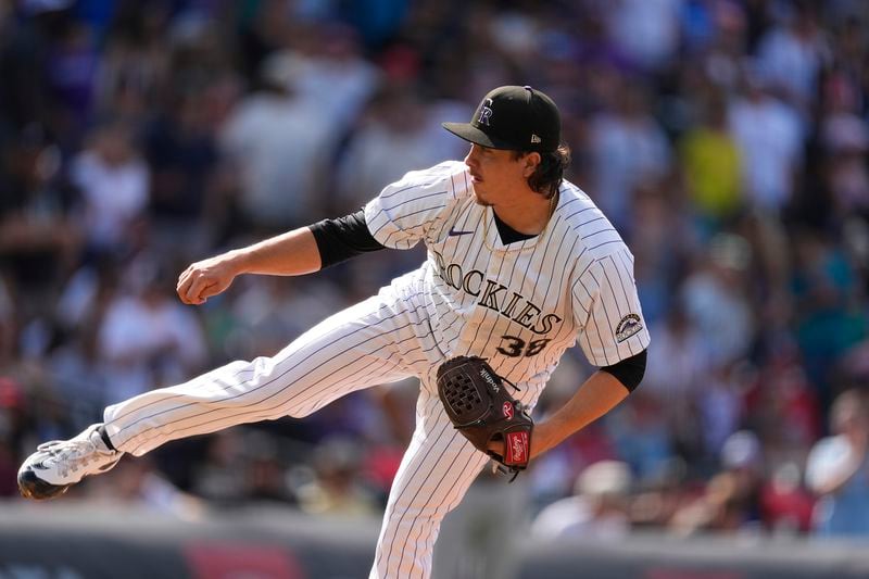 Colorado Rockies relief pitcher Victor Vodnik works against the Atlanta Braves in the ninth inning of a baseball game Sunday, Aug. 11, 2024, in Denver. (AP Photo/David Zalubowski)