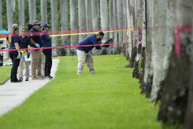 Law enforcement officials work outside of the Trump International Golf Club after the apparent assassination attempt of Republican presidential nominee and former President Donald Trump Monday, Sept. 16, 2024, in West Palm Beach, Fla. (AP Photo/Lynne Sladky)