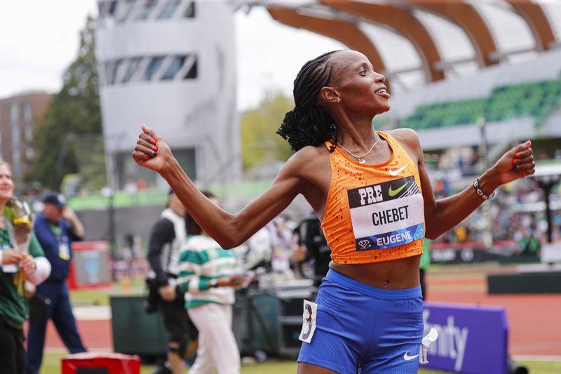 Beatrice Chebet of Kenya, celebrates after setting a world record in the 10,000 with a time of 28:54.14, during the Prefontaine Classic track and field meet Saturday, May 25, 2024, in Eugene, Ore. (AP Photo/Thomas Boyd)