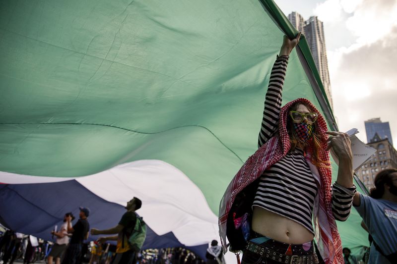 Pro-Palestinian protesters demonstrate outside City Hall, Monday, Oct. 7, 2024, in New York. (AP Photo/Stefan Jeremiah)