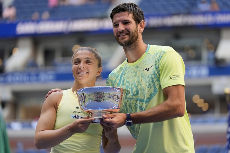 Sara Errani, of Italy, and Andrea Vavassori, of Italy, hold up the championship trophy after defeating Taylor Townsend, of the United States, and Donald Young, of the United States, in the mixed doubles final of the U.S. Open tennis championships, Thursday, Sept. 5, 2024, in New York. (AP Photo/Julia Nikhinson)