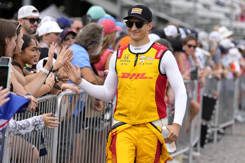 Driver Alex Palou, right, greets fans before an IndyCar auto race Sunday, Sept. 15, 2024, at Nashville Superspeedway in Lebanon, Tenn. (AP Photo/Mark Humphrey)