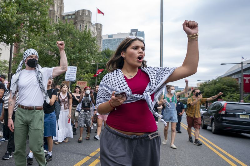 Alia Amanpour Trapp, center, reacts to car horns as she leads the crowd during a pro-Palestine rally and march on Temple University campus in Philadelphia, Aug. 29, 2024. (AP Photo/Chris Szagola)