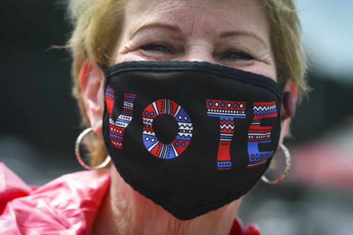 Shirley Connelly stands in line to vote as the first day of early voting is shown underway on Monday, Oct. 12, 2020, at the Gwinnett County Faigrounds in Lawrenceville, Ga. JOHN AMIS FOR THE ATLANTA JOURNAL- CONSTITUTION