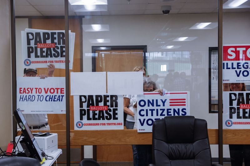 Protesters seekingpaper ballots gather at Hall County's election office Wednesday as Georgia Secretary of State Brad Raffensperger conducts a spot inspection of voting machines. (Natrice Miller/ AJC)