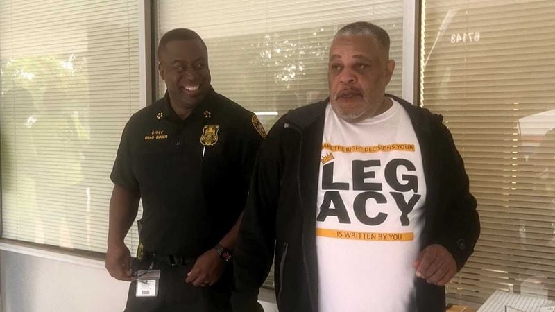 DeKalb County Schools police Chief Bradley Gober (left) and Christopher Beal (right), a retired Clarkston High School principal, share a laugh outside the school district's police headquarters on June 16, 2023. Beal and Gober helped organize a two-week summer program aimed at helping Black male middle school students make good decisions and excel academically. The program was focused in the Clarkston area, but they hope to expand it throughout DeKalb County. (Eric Stirgus/eric.stirgus@ajc.com)