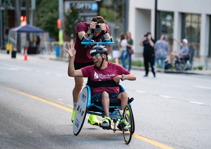 Participants of the push assist division during the 55th running of The Atlanta Journal-Constitution Peachtree Road Race at "Cardiac Hill" on Peachtree Road NW in Atlanta on Thursday, July 4, 2024. (Seeger Gray / AJC)