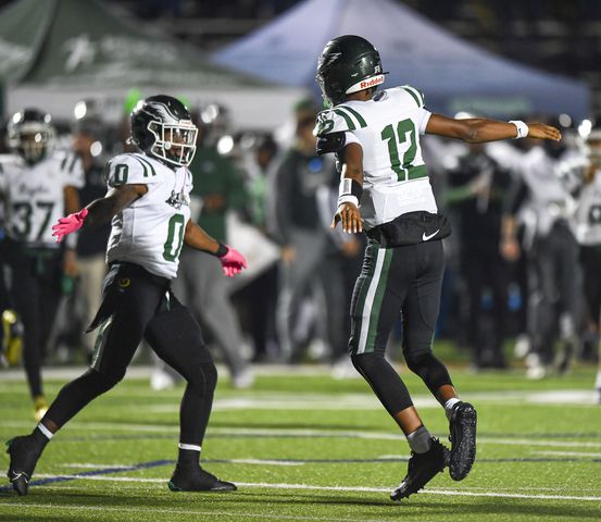 Collins Hill quarterback RJ Wilcox (12) celebrates his touchdown against North Cobb with Jacari Thomas (0) during the first half of play Friday, Nov. 10, 2023 at North Cobb High School. (Daniel Varnado/For the AJC)