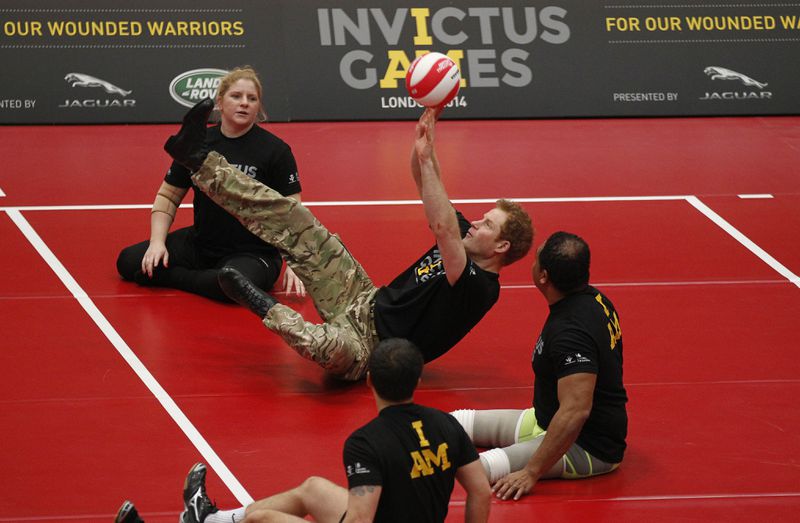 FILE Britain Prince Harry, center, plays a game of sitting volleyball during the launch of the Invictus Games for wounded warriors at the Copper Box arena in the Queen Elizabeth Olympic Park in London, Thursday, March 6, 2014. (AP Photo/Sang Tan, File)