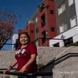 Marina Maalouf, a longtime resident of Hillside Villa who participated in protests after rents doubled in 2019, stands for a photo outside her apartment building in Los Angeles on Wednesday, Sept. 18, 2024. (AP Photo/Jae C. Hong)