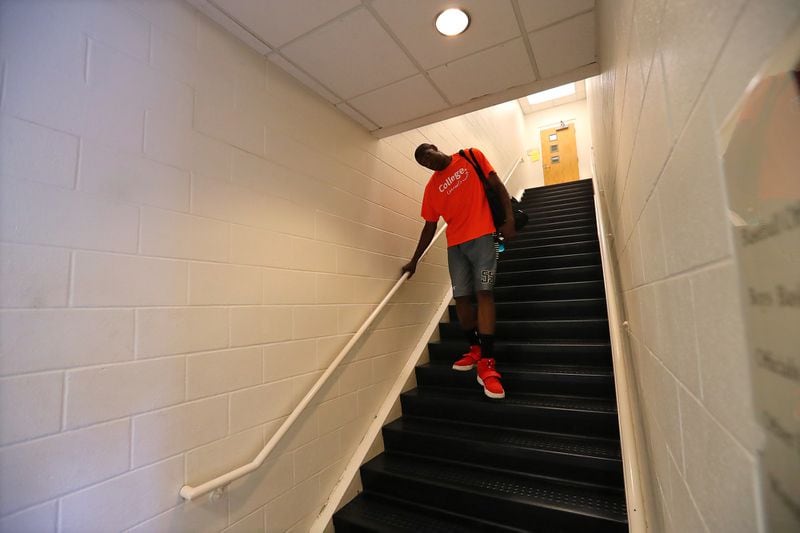 May 20, 2017, Atlanta: Dikembe Mutombo has to duck his head making his way down a flight of stairs to the basketball court for the Breakthrough Atlanta Celebrity Basketball Game at the Lovett School on Saturday, May 20, 2017, in Atlanta.     Curtis Compton/ccompton@ajc.com