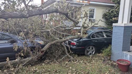 An oak tree limb fell on top of two of Qena Fabin's cars, preventing her from leaving her neighborhood in Augusta, Sunday, September 29, 2024.