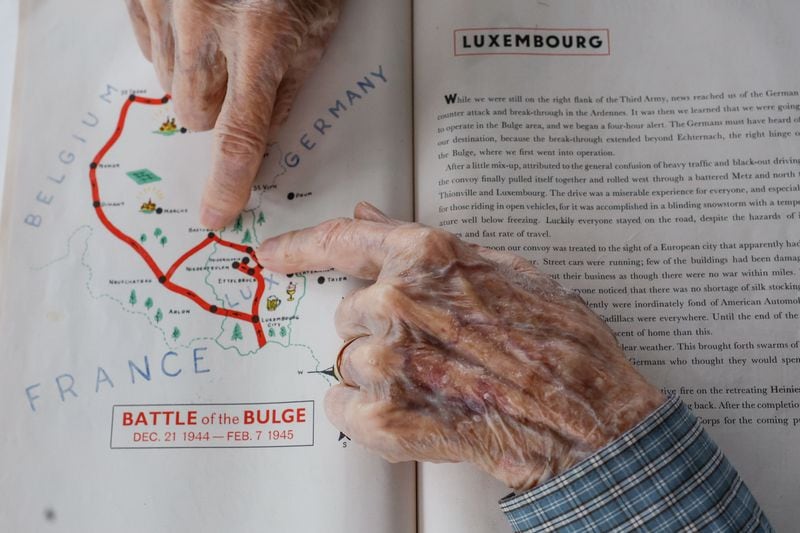 Alan Kinder points to routes he took in Luxembourg during World War II. Kinder, along with other WWII veterans, will visit Normandy for the commemoration of the 80th anniversary of D-Day in June. ( Natrice Miller/ AJC)