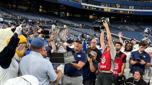 Georgia Southern coach Clay Helton holds the Commissioners Cup after beating Georgia State38-21 at Center Parc Stadium in Atlanta, Sept. 28, 2024. (Photo by Stan Awtrey)