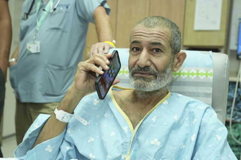 In this photo released by the Israel Prime Minister Office on Tuesday, Aug. 27, 2024, Kaid Farhan Al-Qadi, 52, who was held hostage by Hamas militants in Gaza sits on a sofa in a room at the Soroka Medical Center in Beersheba, Israel. (Israel Prime Minister Office via AP)