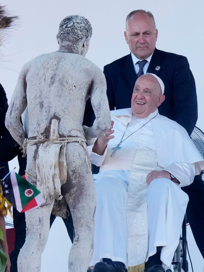 Pope Francis meets a man in traditional dress after giving an address during meeting with young people in the Sir John Guise Stadium in Port Moresby, Papua New Guinea, Monday, Sept. 9, 2024. (AP Photo/Mark Baker)