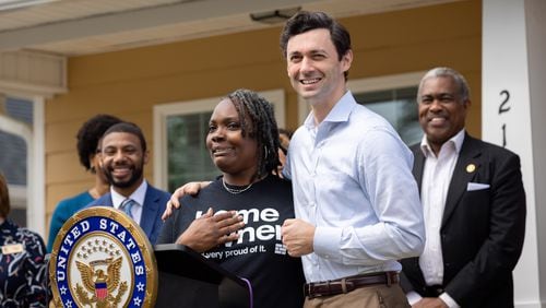 U.S. Sen. Jon Ossoff (right), D-Ga, stands with new homeowner Tanjills Sawyer at a press conference in Hampton on Monday, May 6, 2024. Now, Ossoff has introduced a bill to help renters increase their credit score as they eye the purchase of their first home. (Arvin Temkar / AJC)