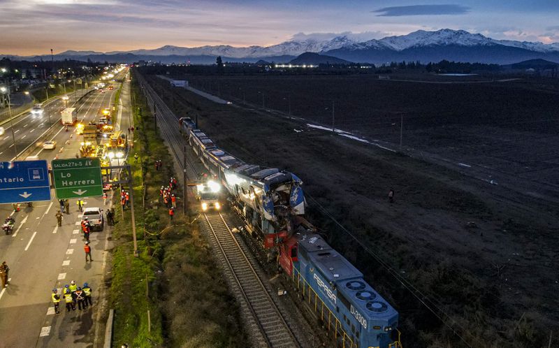 Police inspect two trains that collided in San Bernardo, Santiago, Chile, Thursday, June 20, 2024. (AP Photo/Esteban Felix)