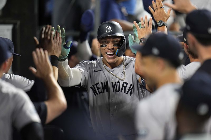 New York Yankees designated hitter Aaron Judge celebrates after hitting his 300th career home run, the fastest player to do so in MLB history, during the eighth inning of a baseball game against the Chicago White Sox, Wednesday, Aug. 14, 2024, in Chicago. (AP Photo/Erin Hooley)