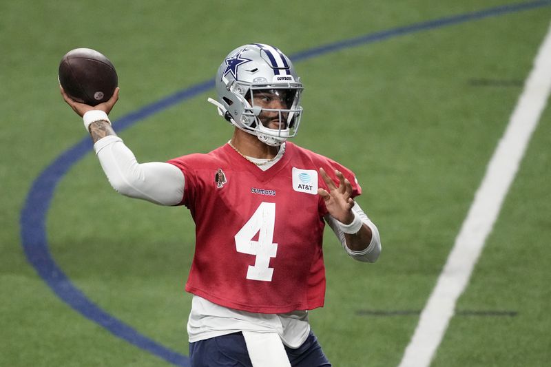 Dallas Cowboys quarterback Dak Prescott (4) throws a pass during an NFL football practice at the team's training facility, Wednesday, Aug. 28, 2024, in Frisco, Texas. (AP Photo/Tony Gutierrez)