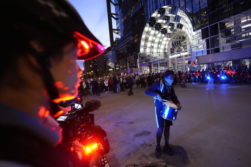 A police officer watches a protest near the Israeli Consulate during the Democratic National Convention Tuesday, Aug. 20, 2024, in Chicago. (AP Photo/Alex Brandon)