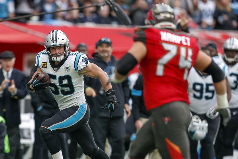 FILE - Carolina Panthers middle linebacker Luke Kuechly (59) returns a fumble recovery against the Tampa Bay Buccaneers during the third quarter of an NFL football game, Sunday, Oct. 13, 2019, at Tottenham Hotspur Stadium in London. (AP Photo/Alastair Grant, File)