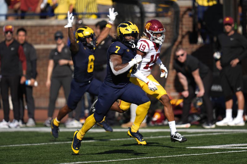 Michigan running back Donovan Edwards (7) runs for a 41-yard touchdown as Southern California cornerback John Humphrey (19) defends in the first half of an NCAA college football game in Ann Arbor, Mich., Saturday, Sept. 21, 2024. (AP Photo/Paul Sancya)