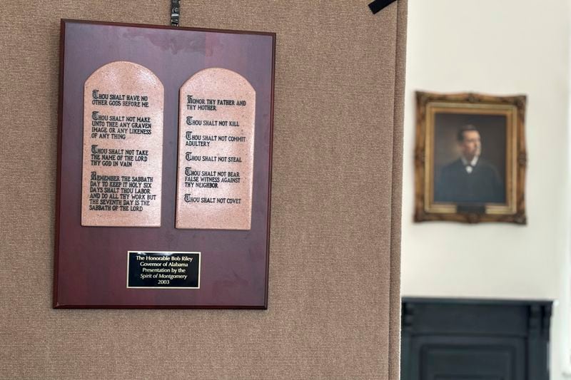 A copy of the Ten Commandments hangs in the Alabama Capitol in Montgomery, Ala., Thursday, June 20, 2024. The wooden plaque hangs next to a display titled "The Foundation of Our Law" that also includes information about the Magna Carta and the Mayflower Compact. The display sits in a room that housed the Alabama Supreme Court library between 1885 and 1940 and is now used for historical displays. (AP Photo/Kim Chandler)