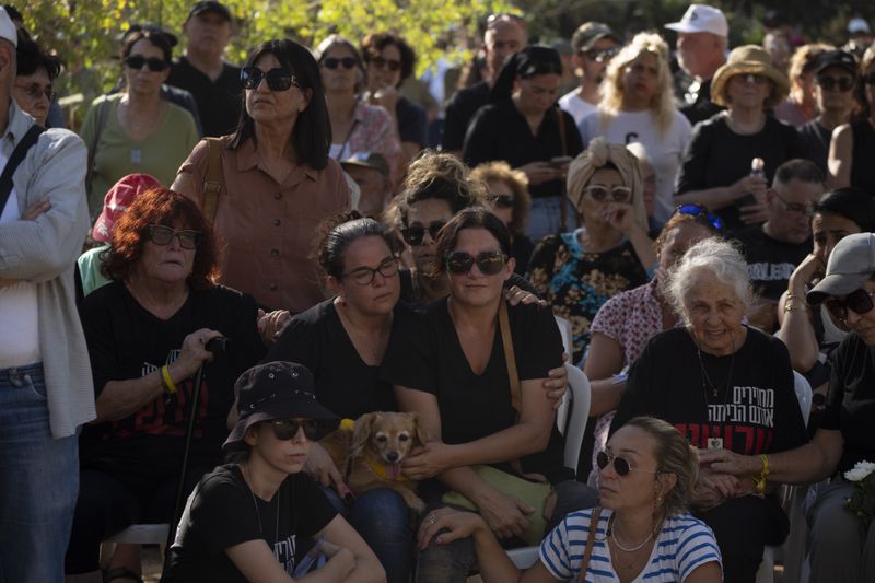 Rimon Buchshtab, center, mourns during the funeral of her husband Yagev Buchshtab at a cemetery of the kibbutz Nirim, southern Israel, Wednesday, Aug. 21, 2024. Buchshtab's body was one the six bodies of hostages, taken in Hamas' Oct. 7 attack, recovered by Israel's military during an operation in the Gaza Strip. (AP Photo/Leo Correa)