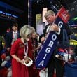 Ginger Howard signs on Georgia delegate marker as Brad Hughes holds during the final day of 2024 Republican National Convention, Thursday, July 18, 2024, in downtown Milwaukee, WI. (Hyosub Shin / AJC)