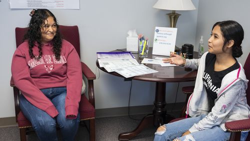 Martha Alicia Jimenez Zarco (left) and her daughter Blanca Estela Torres Jimenez (right) meet with advisers at the International Newcomer Center to fill out paperwork to enroll in the Gwinnett County school system on Monday, Oct. 9, 2023. (Olivia Bowdoin for The Atlanta Journal-Constitution)