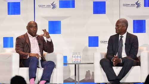 (Left to right) President and CEO at the American College of Financial Services George Nichols speaks to Raphael Bostic, president and CEO of the Federal Reserve Bank of Atlanta, at the Conference of African American Financial Professionals in Atlanta on Tuesday, Aug. 13, 2024. (Natrice Miller/ AJC)