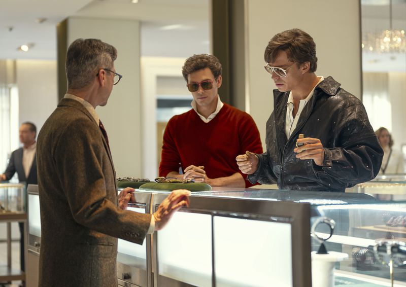 This image released by Netflix shows Cooper Koch as Erik Menendez, center, and Nicholas Chavez as Lyle Menendez, right, in a scene from "Monsters: The Lyle And Erik Menendez Story." (Miles Crist/Netflix via AP)