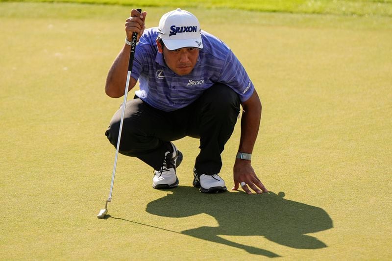 Hideki Matsuyama, of Japan, lines up a putt on the 18th green during the first round of the Tour Championship golf tournament, Thursday, Aug. 29, 2024, in Atlanta. (AP Photo/Mike Stewart)