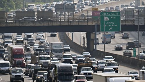 Traffic slowly moves along Interstate 85 near Spaghetti junction on May 24 in Atlanta. (Hyosub Shin/The Atlanta Journal-Constitution)