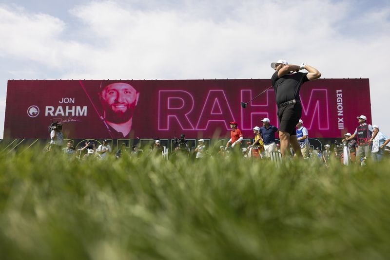 Captain Jon Rahm, front right, of Legion XIII, hits from the first tee during the final round of LIV Golf Chicago at Bolingbrook Golf Club, Sunday, Sept. 15, 2024, in Bolingbrook, Ill. (Chris Trotman/LIV Golf via AP)