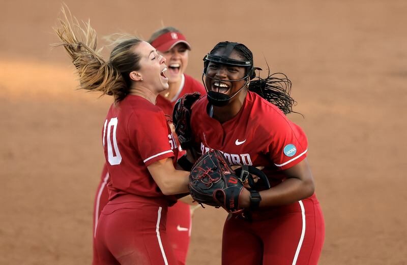 Stanford pitcher NiJaree Canady (24) celebrates with Jade Berry (10) as River Mahler (1) runs in after the final out of the double elimination game as the Stanford Cardinal played the CSU Fullerton Titans in an NCAA softball regional tournament at Stanford, Calif., on Sunday May 19, 2024. Stanford won 4-2 and will advance. (Carlos Avila Gonzalez/San Francisco Chronicle via AP)