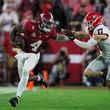 Alabama quarterback Jalen Milroe (4) runs for a first down against Georgia defensive back Dan Jackson (17) during the second quarter at Bryant-Denny Stadium, Saturday, Sept. 28, 2024, in Tuscaloosa, Al. (Jason Getz / AJC)

