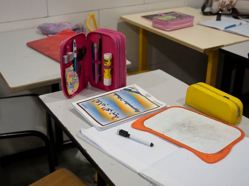 School supplies sit on a student's desk at a religious studies class for elementary school students at the Cedres Mosque in Marseille, southern France, Wednesday, April 17, 2024. (AP Photo/Daniel Cole)