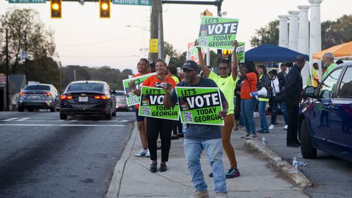 Bobby Adams (front), from the SCLC, encourages citizens to vote on Tuesday, November 8, 2022, across the street from the Metropolitan Library in Atlanta. Voters cast their ballots for the midterm elections. CHRISTINA MATACOTTA FOR THE ATLANTA JOURNAL-CONSTITUTION.