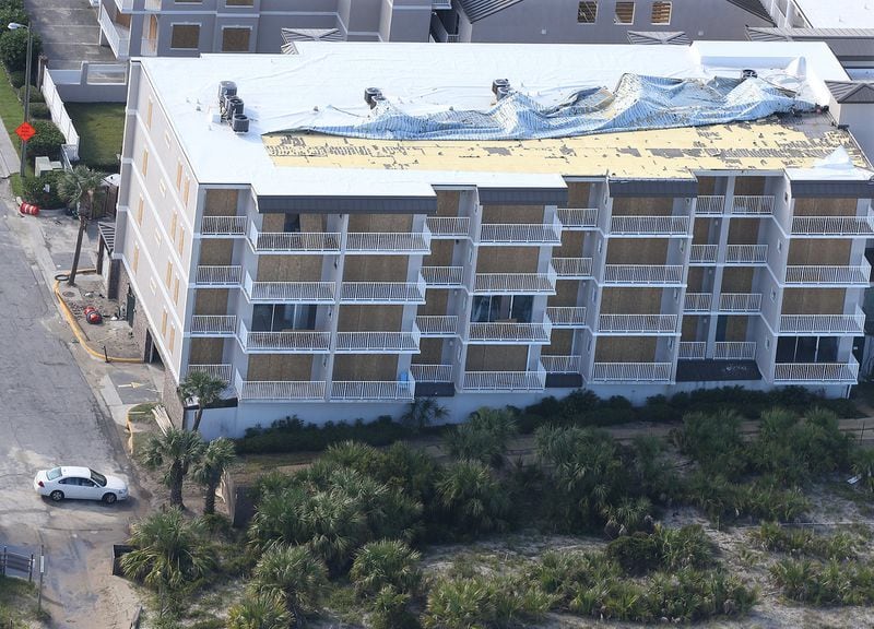 The roof of a boarded up hotel on Tybee Island shows storm damage after Hurricane Irma. Metro Atlanta hotels saw an increase in occupancy following the storm. Curtis Compton/ccompton@ajc.com AJC FILE PHOTO