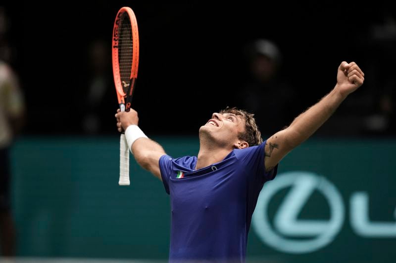 Italy's Flavio Cobolli celebrates beating Netherlands' Tallon Griekspoor during their Davis Cup tennis match, at the Unipol Arena, in Bologna, Italy, Sunday, Sept. 15, 2024. (Massimo Paolone/LaPresse via AP)