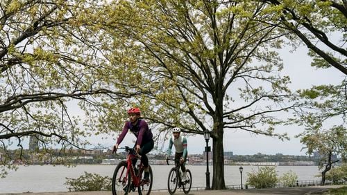 Cyclists ride along the Hudson River Greenway in Riverside Park in New York, May 8, 2022. Biking is a great way to get outside, but it’s also a way to improve fitness, if you approach it with the right equipment and training. (Karsten Moran/The New York Times)